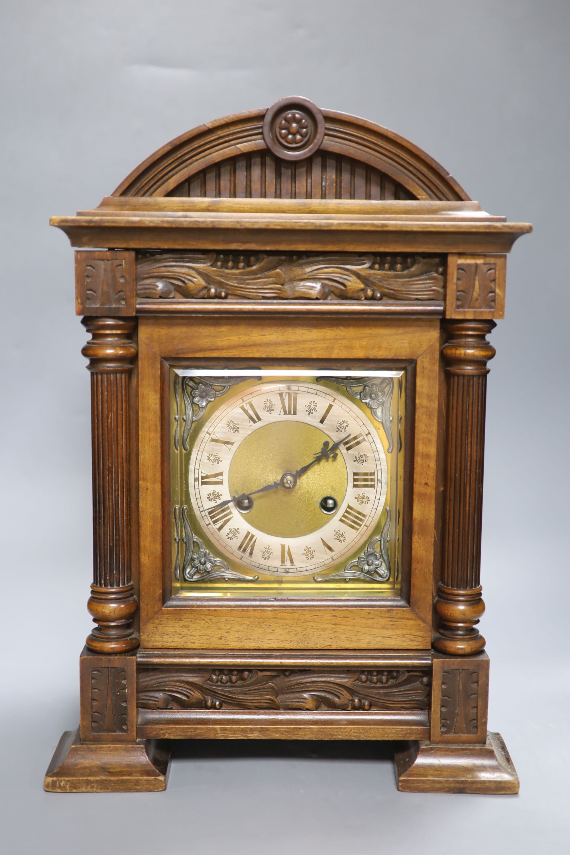 A German walnut mantel clock, converted to electric regulation, height 44cm